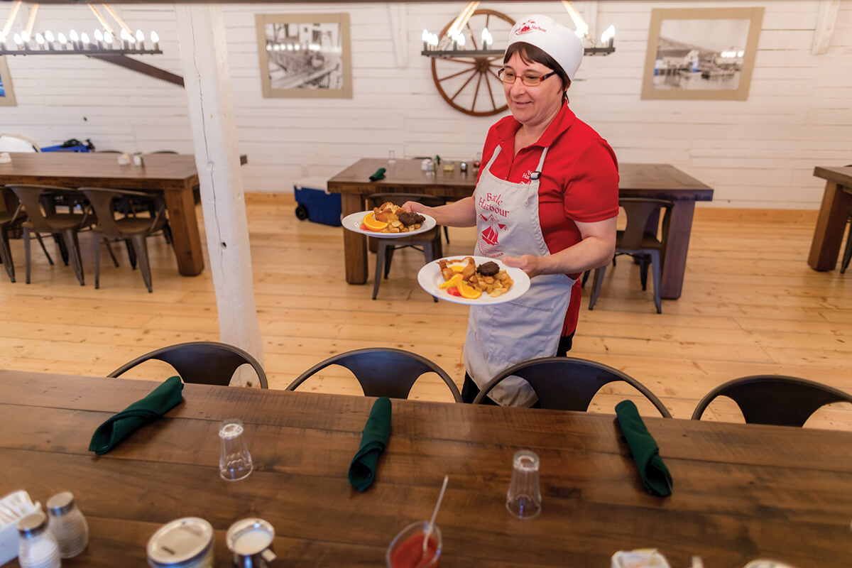 lady in Battle Harbour kitchen